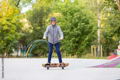 Skater girl on skatepark moving on skateboard outdoors. Copy space