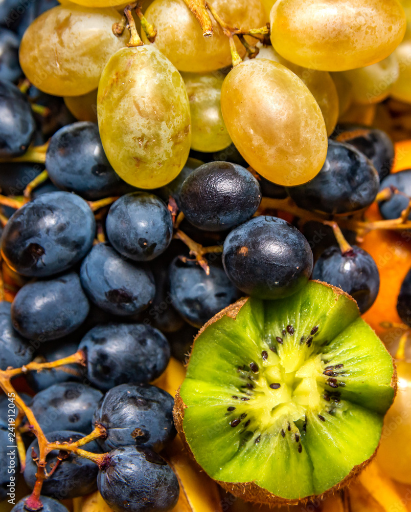 Fototapeta premium Fresh fruit salad made of banana, kiwi, and grapes pieces