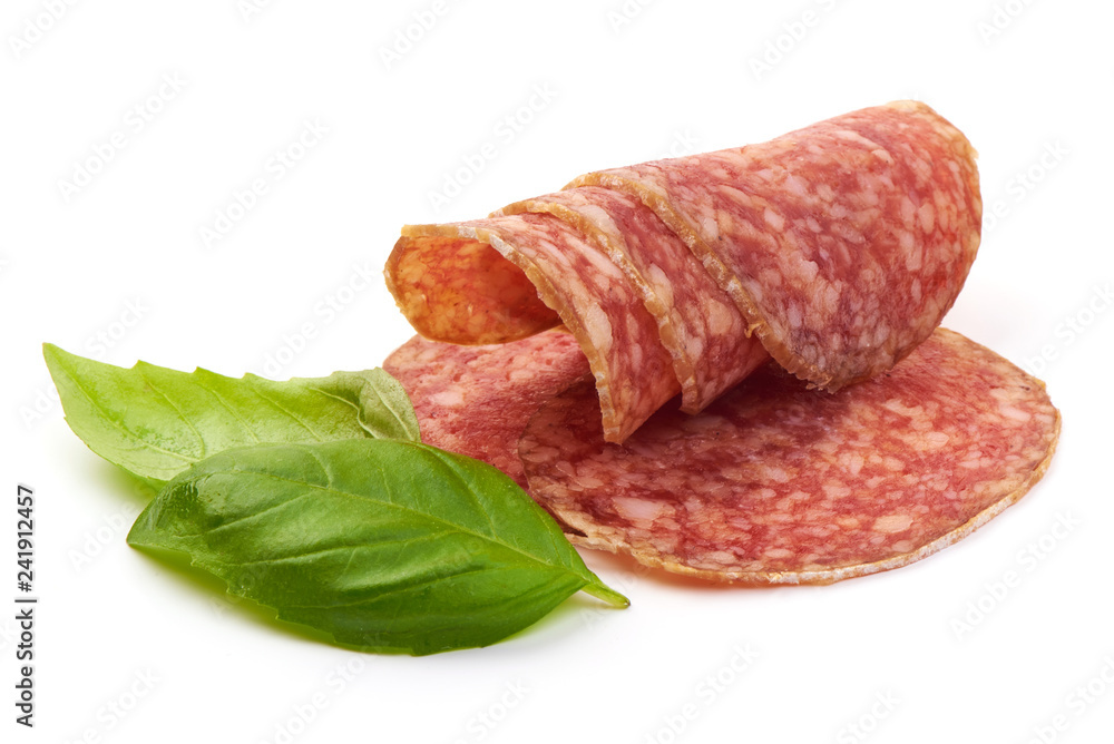 Smoked Salami Slices with basil leaves, isolated on a white background. Close-up Smoked Salami Slices with basil leaves, isolated on a white background. Close-up