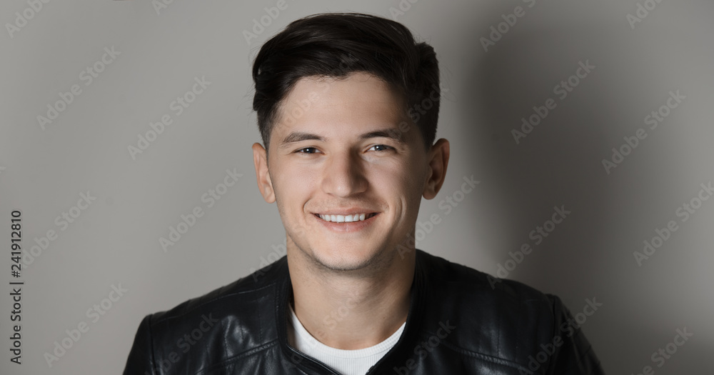 Studio portrait of smiling young modern guy. Studio portrait of smiling young modern guy.