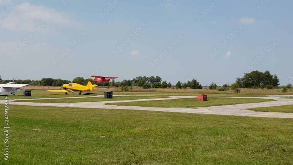 red plane with a propeller sits down and takes off at the airport red plane with a propeller sits down and takes off at the airport