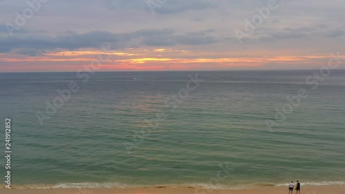 beautiful sunset over coconut trees at Karon beach Phuket photo