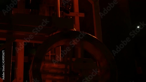 Spinning wooden wheel and a discending metallic chain of a water mill model  photo