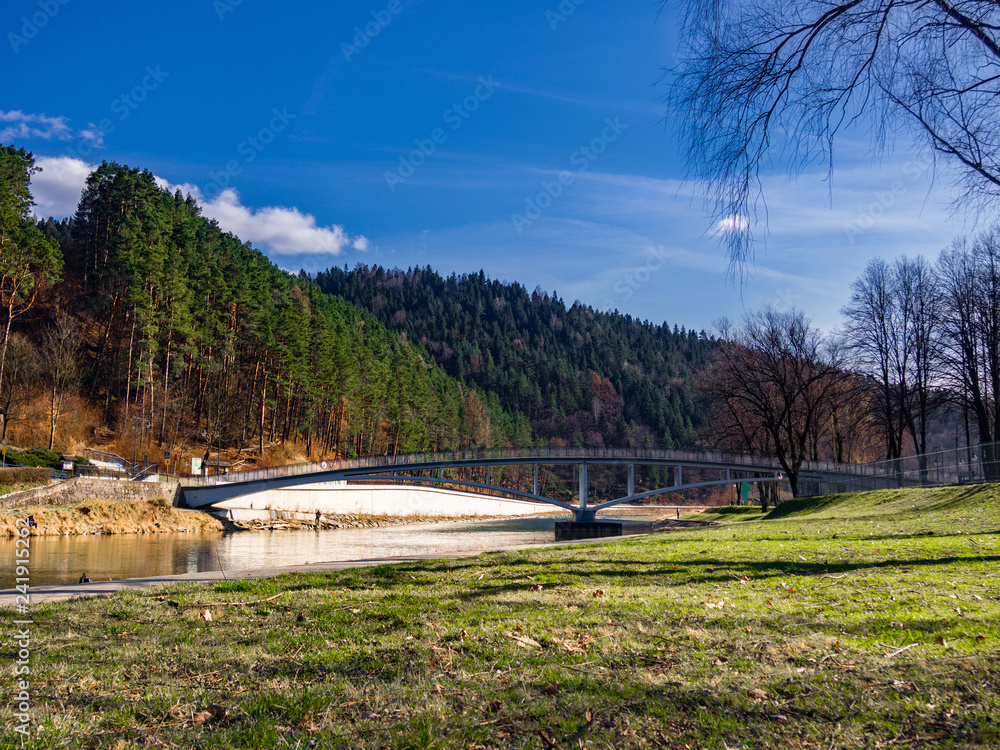 Poprad River in spring near Piwniczna-Zdroj Town, Poland. Bridge across river.