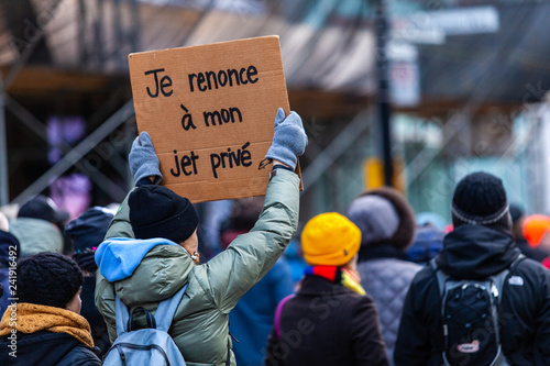 Activists marching for the environment. French sign seen in an ecological protest saying i renounce to my private jet © Valmedia