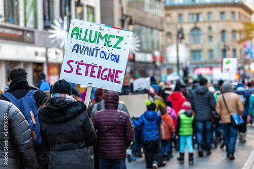 Activists marching for the environment. French sign seen in an ecological protest saying Light up before we switch off © Valmedia