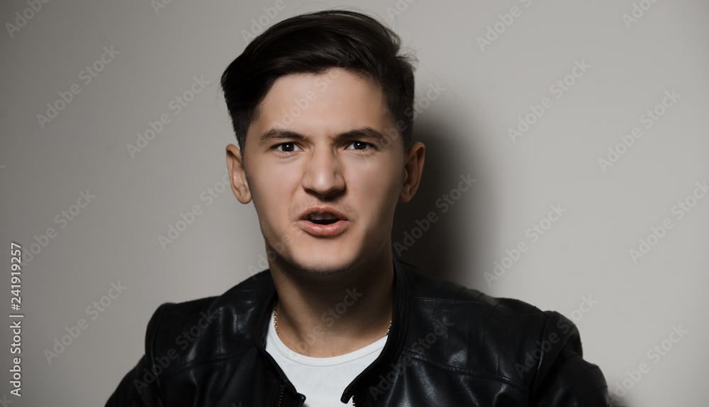 Portrait of emotional screaming young guy, background of grey. Portrait of emotional screaming young guy, background of grey.