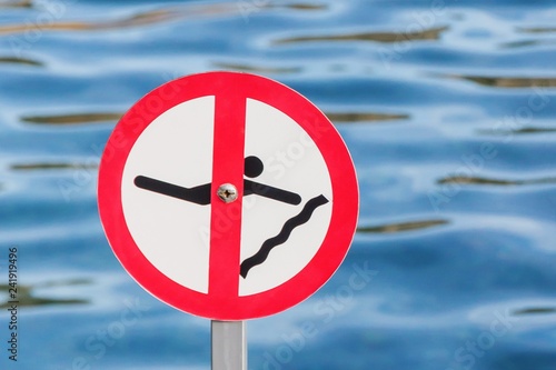 No diving or jumping sign on the water background