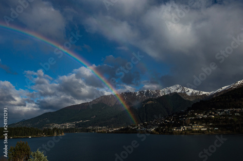 lake in the mountains with rainbow and clouds