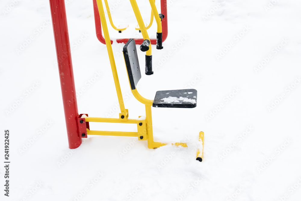 Street workout equipment in winter, outdoor sport fitness and bodybuilding Street workout equipment in winter, outdoor sport fitness and bodybuilding