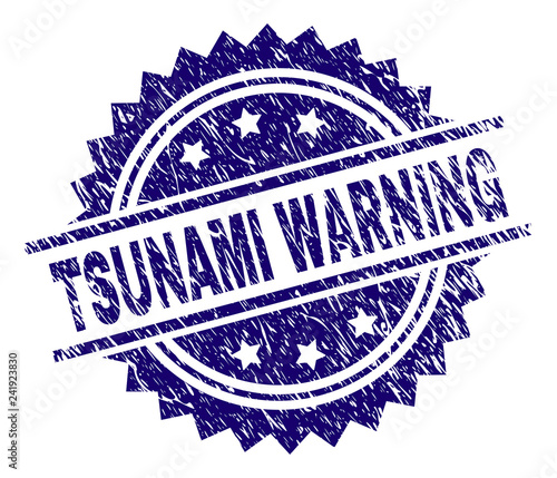 TSUNAMI WARNING stamp seal watermark with distress style. Blue vector rubber print of TSUNAMI WARNING tag with retro texture.