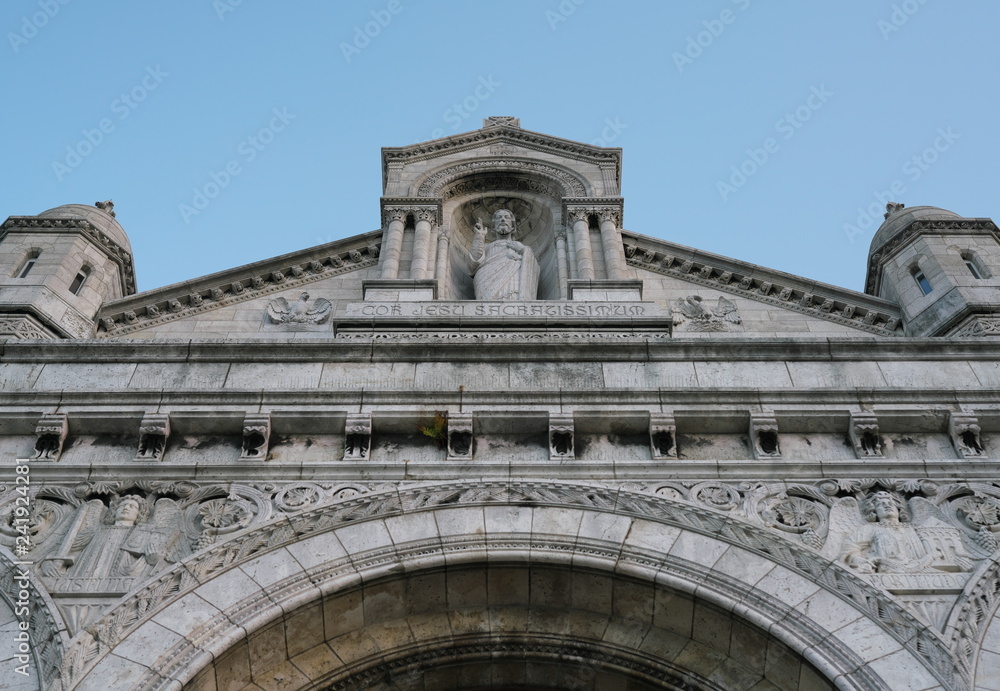 Paris,France-October 17, 2018: A facade and a statue of Jesus Christ of Sacre Coeur in Montmartre, Paris  
