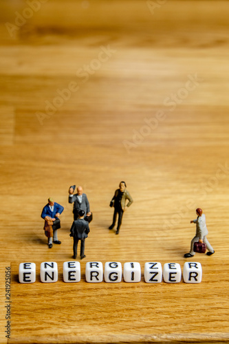 little miniature figurines with little dices forming word energizer as a part of team meeting collection pictures photo