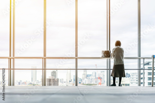 asia businesswoman stand on window