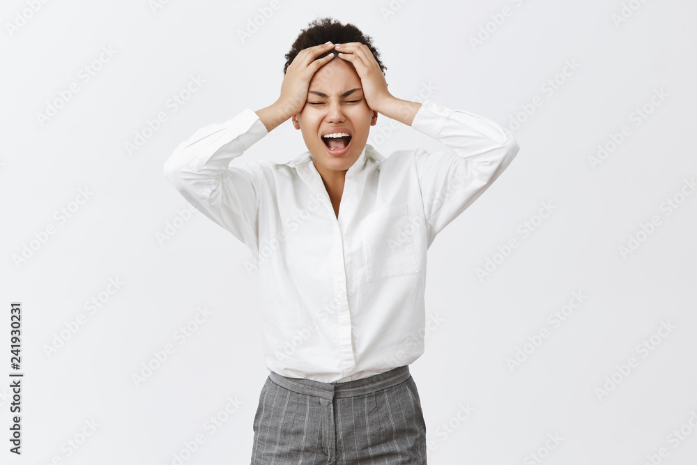 Hate mondays. Unhappy bothered and distressed young determined businesswoman in formal outfit, yelling from stress and unpleasant feelings in soul, holding hands on head, tired and exhausted Hate mondays. Unhappy bothered and distressed young determined businesswoman in formal outfit, yelling from stress and unpleasant feelings in soul, holding hands on head, tired and exhausted