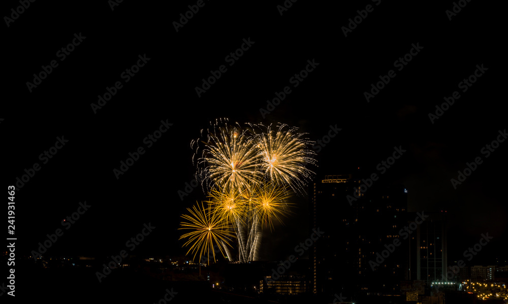 Colorful fireworks display over city . Firework celebration sparkling in midnight sky, countdown , khonkaen, Thailand