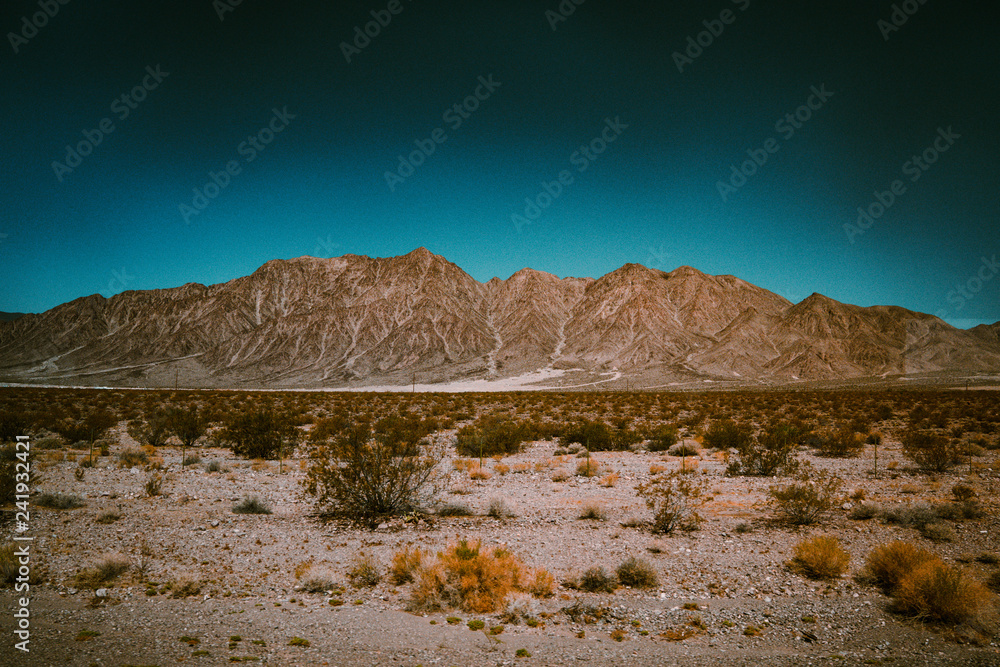 desert in the mountains with a cool blue sky