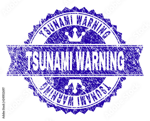 TSUNAMI WARNING rosette stamp seal watermark with grunge texture. Designed with round rosette, ribbon and small crowns. Blue vector rubber watermark of TSUNAMI WARNING caption with scratched texture.