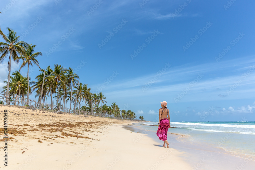 Beautiful woman walking in a empty beach in Caribe Beautiful woman walking in a empty beach in Caribe