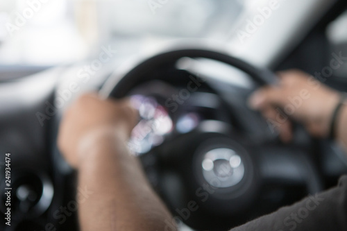 Men's hand holding the steering wheel