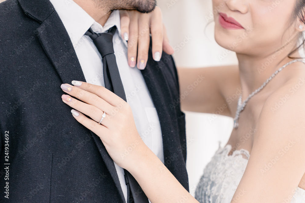 Naklejka premium Groom holding Bride with happyness in wedding suit