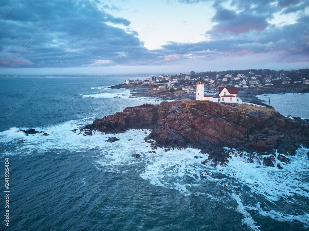 Aerial drone image of The Nubble Lighthouse on its rocky island ion a winter morning sunrise Aerial drone image of The Nubble Lighthouse on its rocky island ion a winter morning sunrise