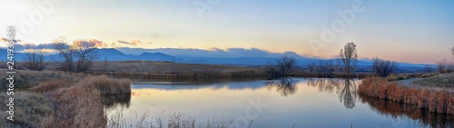 Εκτύπωση καμβά Views of Josh’s Pond walking path, Reflecting Sunset in Broomfield Colorado surrounded by Cattails, plains and Rocky mountain landscape during sunset