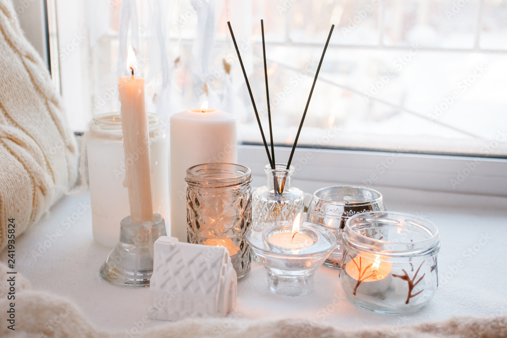 aroma stick near window with candles in the morning, winter spring cozy light monochrome background aroma stick near window with candles in the morning, winter spring cozy light monochrome background
