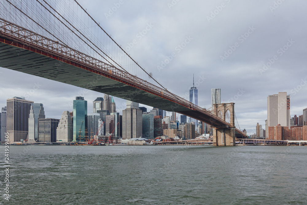 Manhattan skyline viewed from Brooklyn with Brooklyn bridge, in New York City, USA