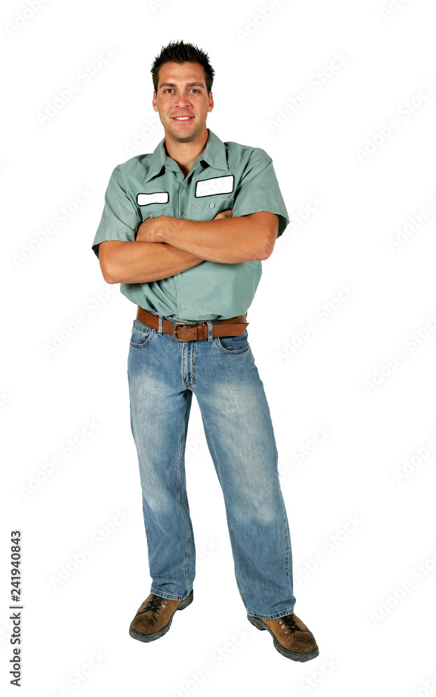 An adult male serviceman employee worker with blank name tag on shirt standing with his arms folded. An adult male serviceman employee worker with blank name tag on shirt standing with his arms folded.