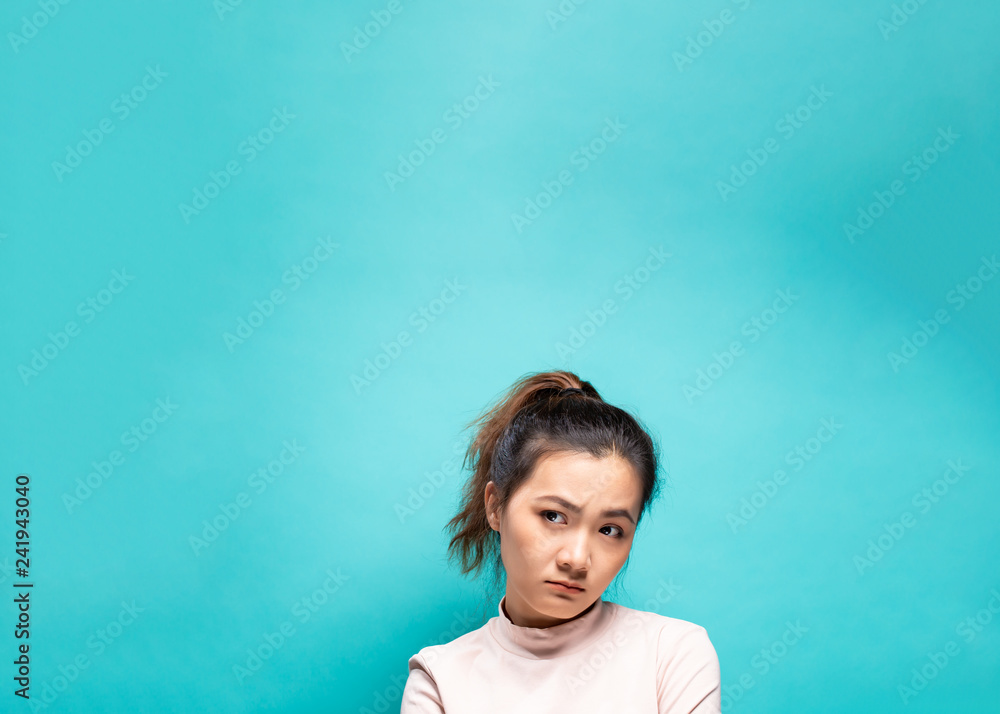 Portrait of serious woman on a blue background Portrait of serious woman on a blue background