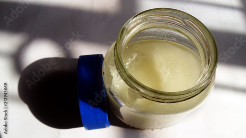 Coconut Oil In The Bottle and Sunshine Fall Into it.   