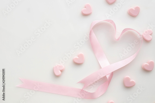 Fototapeta Naklejka Na Ścianę i Meble -  pink ribbon heart shape on isolated white background, Velentine's day Background.