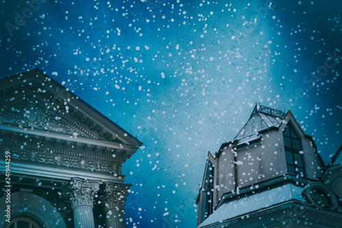 The facade of a classic buildings on a background of black under the snow