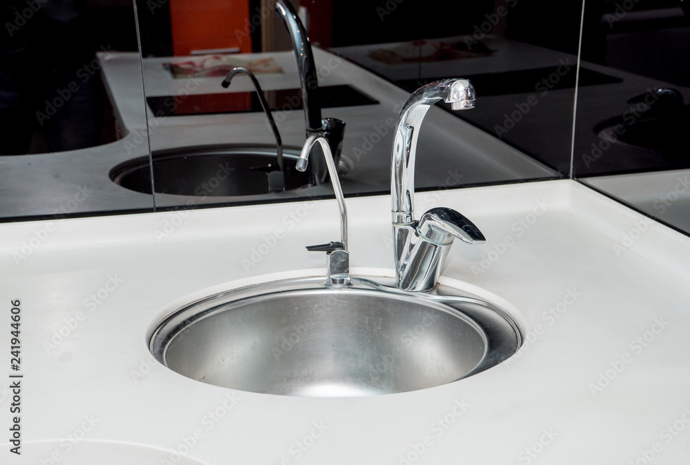 The photo of a sink in a bathroom The photo of a sink in a bathroom