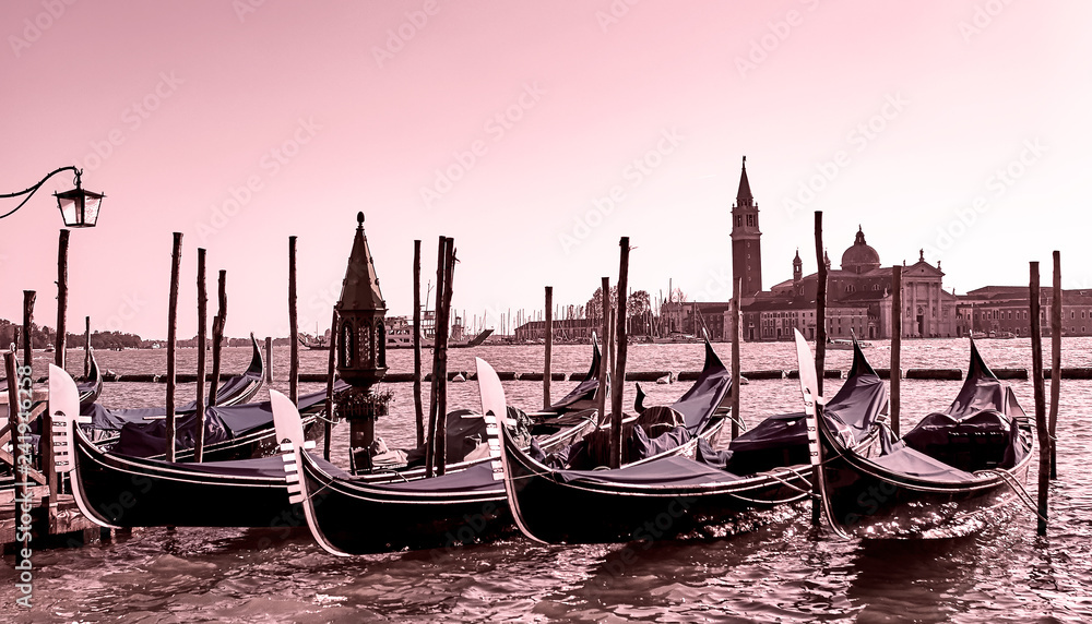 Gondolas docked at the pier the Piazza San Marco in Venice, Italy at sunrise