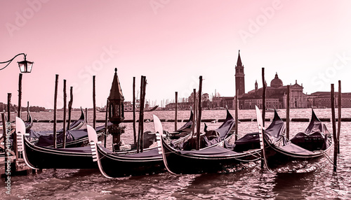 Gondolas docked at the pier the Piazza San Marco in Venice, Italy at sunrise © zenobillis