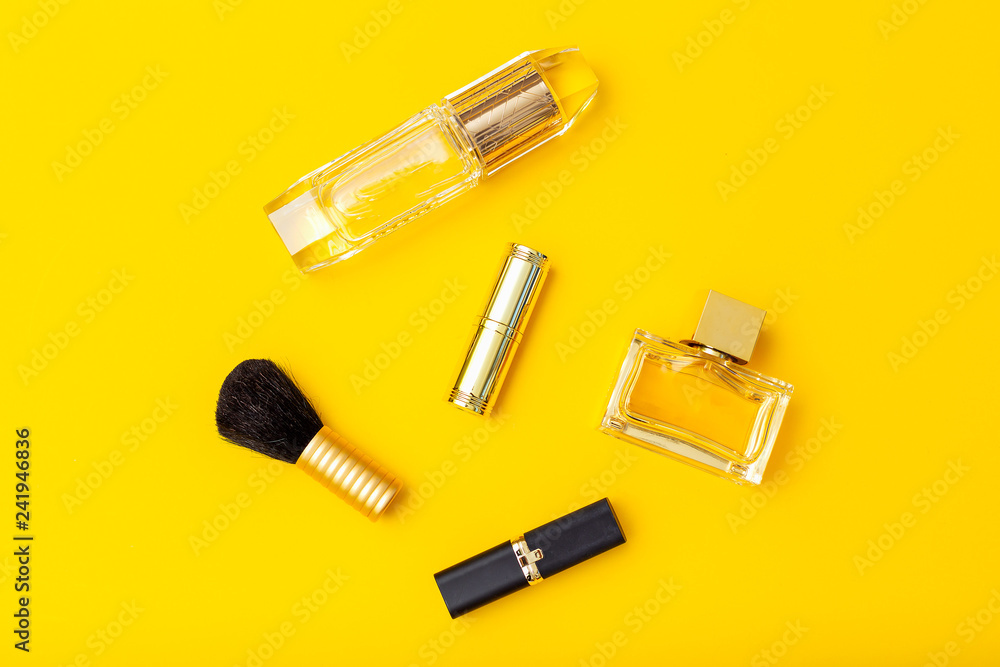 Make up gold color on yellow background. Flat lay Make up gold color on yellow background. Flat lay