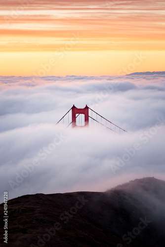 Photography Golden Gate Bridge tower above the blanket of fog with brilliant sunrise colors