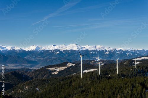 Distant view of snowy mountain peaks and windmills