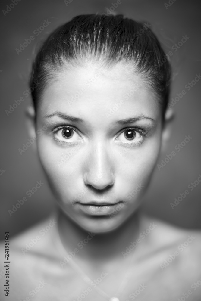 Fototapeta premium Young girl with beautiful skin and no makeup in black and white.