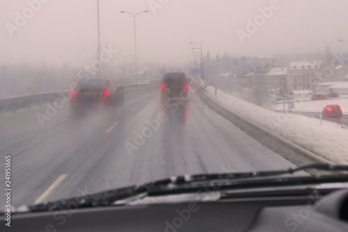 Heavy traffic on a road during winter, difficult condition with low visibility for driving, higher risk of crash