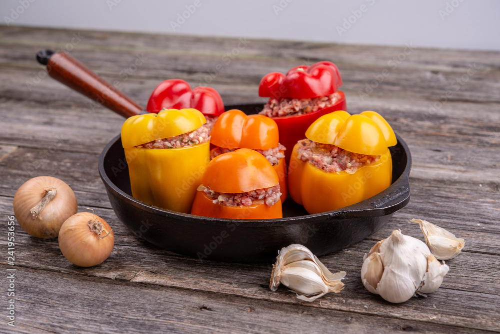 colorful filled pepper,garlic and onion in iron pan from above