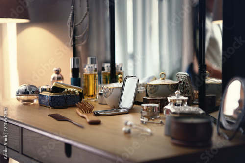Fotografia, Obraz many stuffs on a dressing table in a bedroom