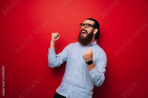 Fototapeta Photo of screaming bearded boy, celebrate his winn