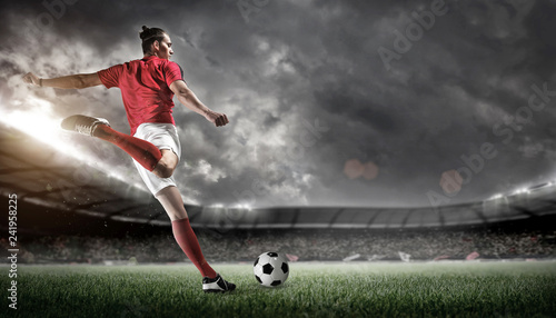 Soccer player in action on stadium background. photo