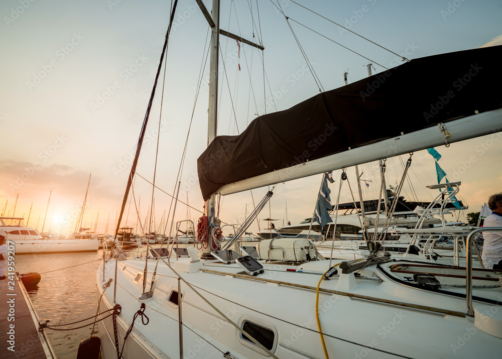Fototapeta premium View of harbor with yachts details. Beautiful sunset sky in the marina bay.