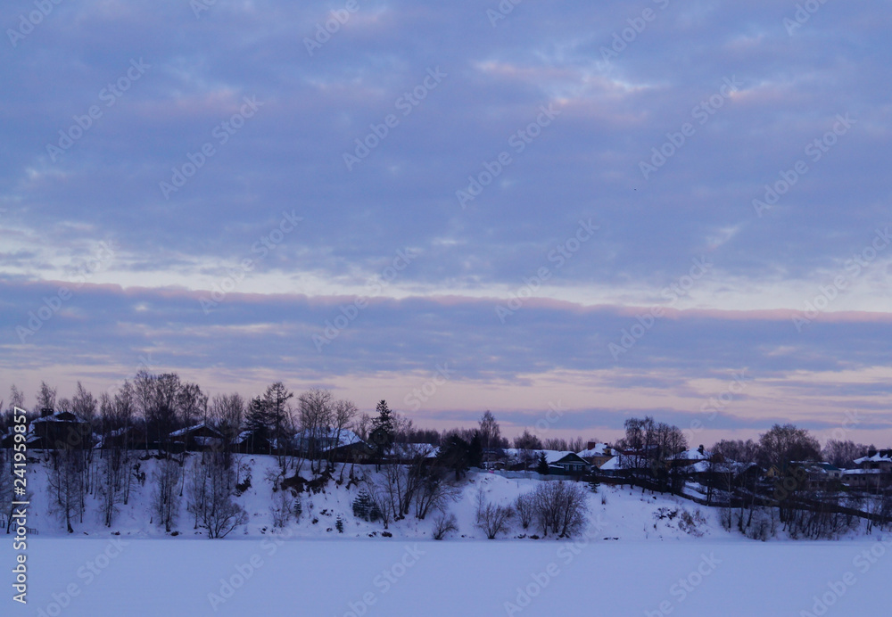 Snow covered trees in the mountains at sunset. Beautiful winter landscape