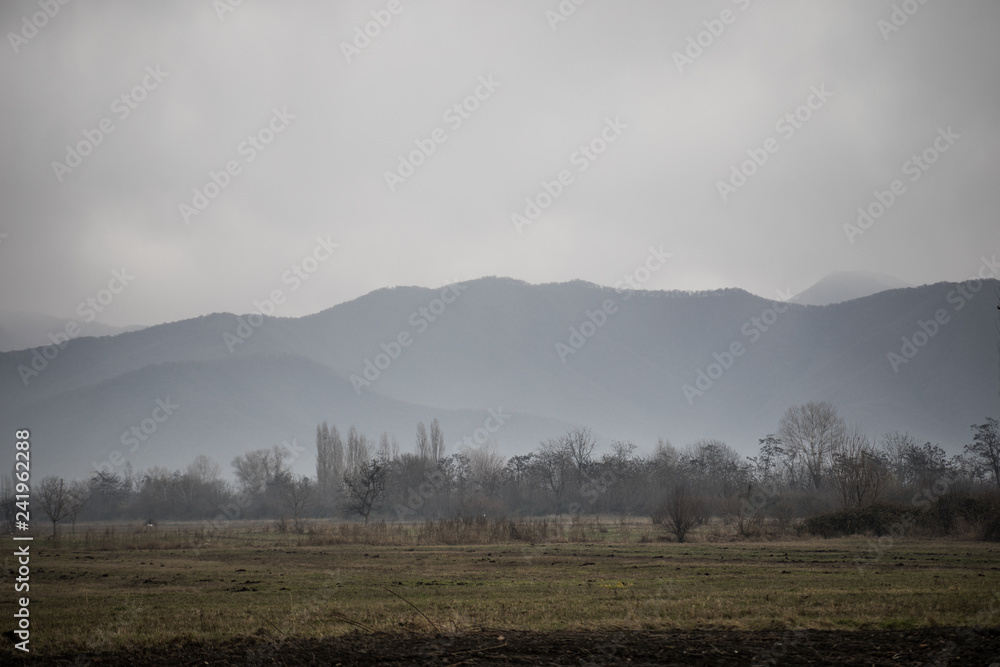 Fototapeta premium Panorama of the foggy winter landscape in the mountains with snow and rocks, Beautiful landscape of winter nature of Azerbaijan