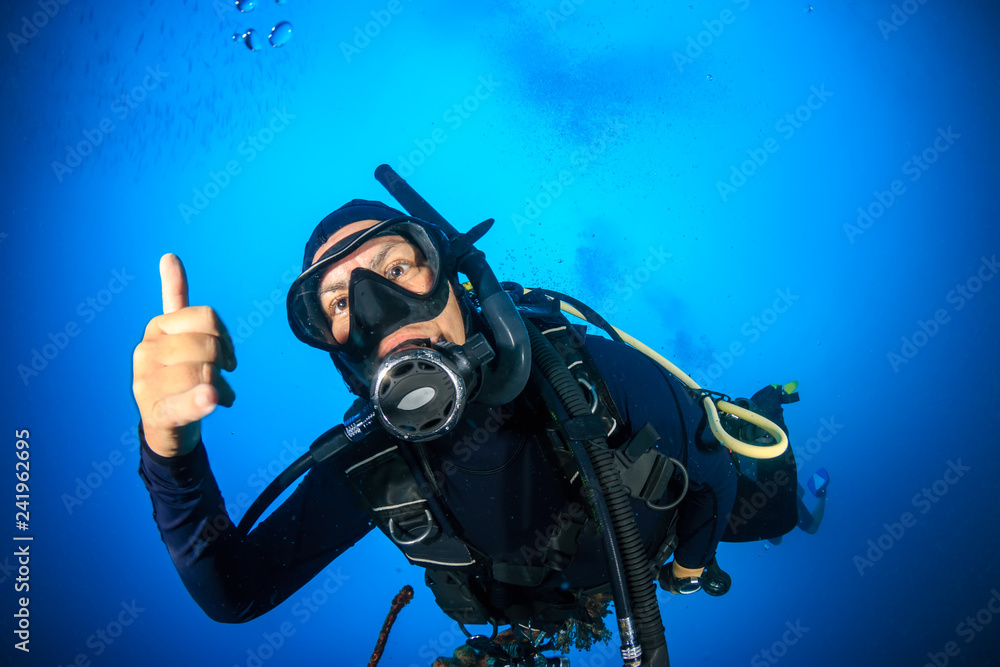Female SCUBA diver on a tropical coral reef Female SCUBA diver on a tropical coral reef